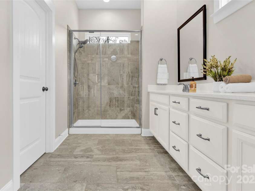 12424 Bradford Park Drive, Davidson, NC 28036.  MLS# CAR4241762, YatesRealty ID 4355. Primary Bath with spacious walk-in shower.