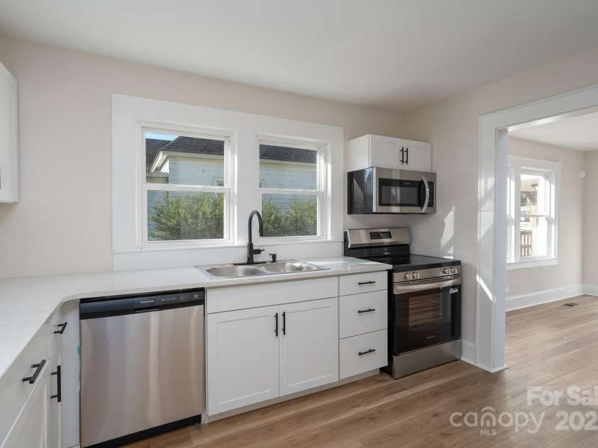 702 3rd Street, Spencer, NC 28159.  MLS# CAR4309115, YatesRealty ID 43594. Kitchen has been updated with new cabinets, new quartz countertops new dishwasher, new sink, new microwave, new electric range and LVP flooring. Fresh paint.