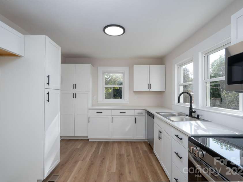 702 3rd Street, Spencer, NC 28159.  MLS# CAR4309115, YatesRealty ID 43594. Kitchen has new cabinets, new dishwasher, new sink, new quartz countertops, new microwave, new electric range and new LVP flooring.