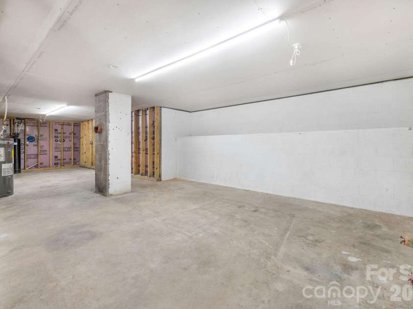 104 Justice Ridge Road, Candler, NC 28715.  MLS# CAR4396545, YatesRealty ID 43609. Full unfinished basement/workshop area w/ drywall