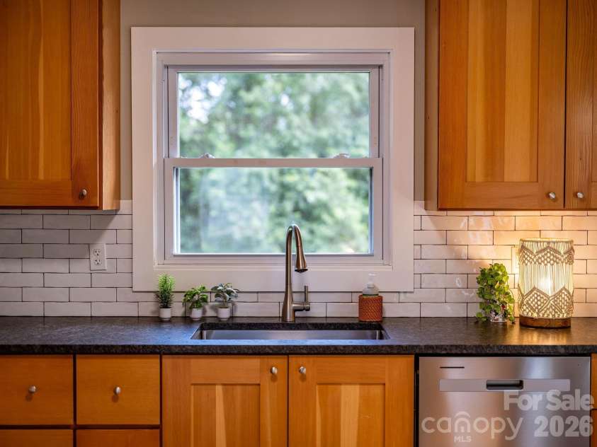 104 Justice Ridge Road, Candler, NC 28715.  MLS# CAR4396545, YatesRealty ID 43609. Sink window overlooking that large back yard
