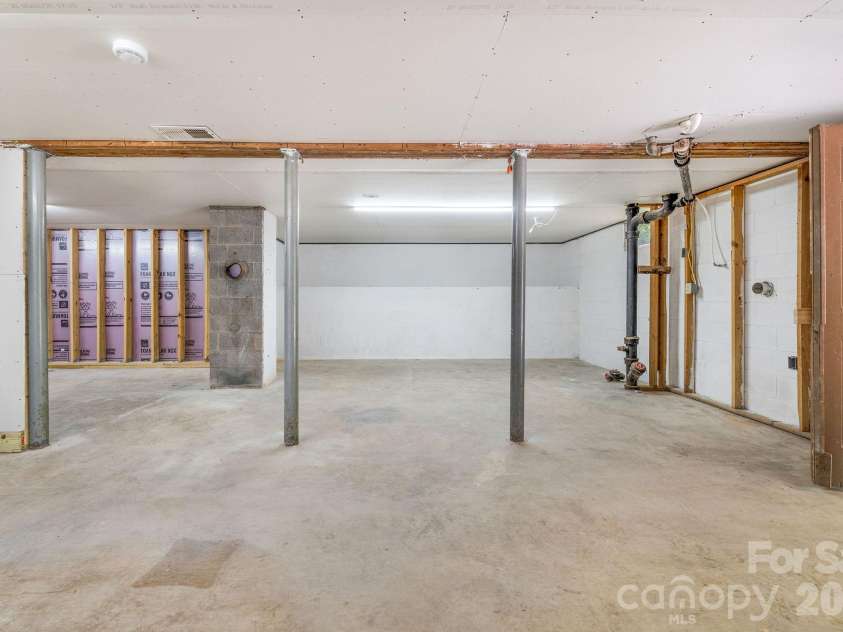 104 Justice Ridge Road, Candler, NC 28715.  MLS# CAR4396545, YatesRealty ID 43609. Ull unfinished basement/workshop area w/ drywall