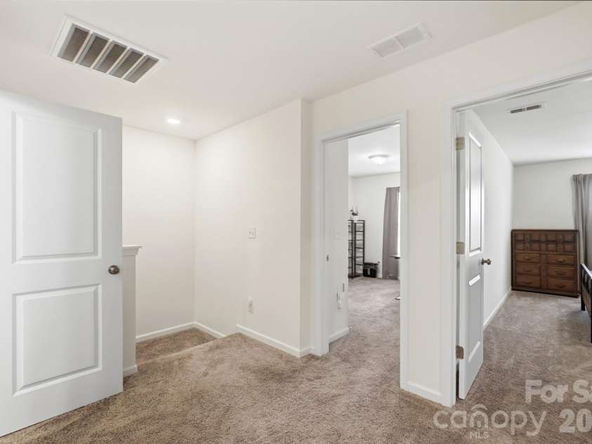 5243 Maynard Hill Drive, Monroe, NC 28110.  MLS# CAR4413326, YatesRealty ID 43634. Hallway looking into secondary bedrooms.