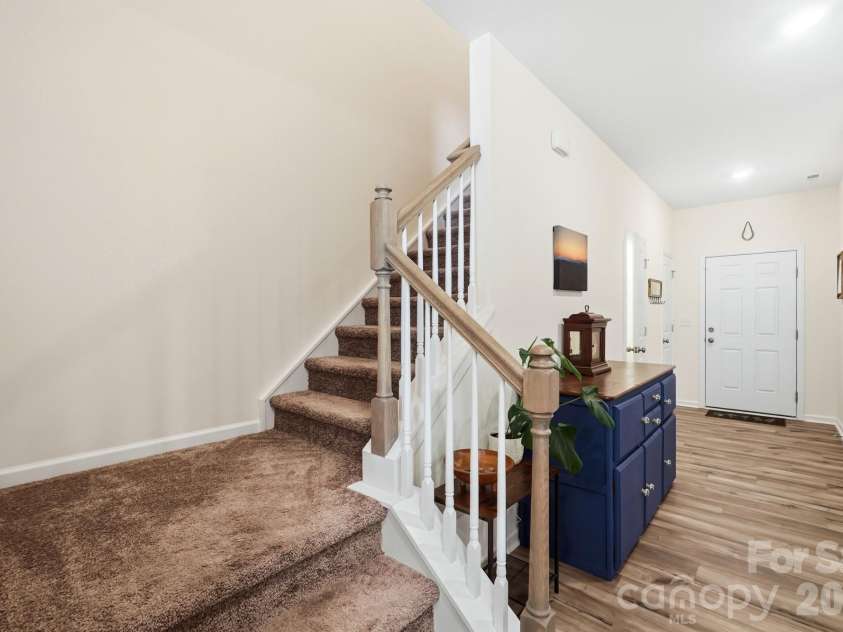 5243 Maynard Hill Drive, Monroe, NC 28110.  MLS# CAR4413326, YatesRealty ID 43634. Stairs near front entry and Kitchen Island.
