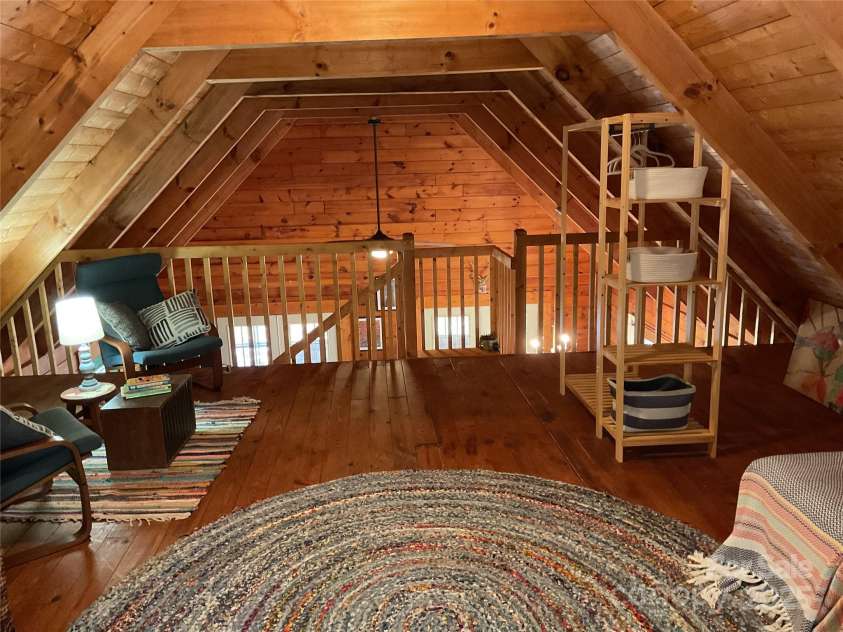 1446 Mcguinn Road, Mill Spring, NC 28756.  MLS# CAR4195239, YatesRealty ID 4367. From the loft BR area, looking towards the staircase and main living area.