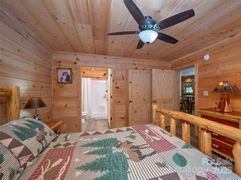 344 Wolf Trail, Lake Lure, NC 28746.  MLS# CAR4126442, YatesRealty ID 4372. Primary bedroom ensuite with large oversized shower and walk-in closet.