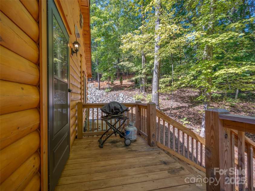344 Wolf Trail, Lake Lure, NC 28746.  MLS# CAR4126442, YatesRealty ID 4372. Wraparound side porch from front deck is accessible from the main kitchen making the perfect place for grilling out!