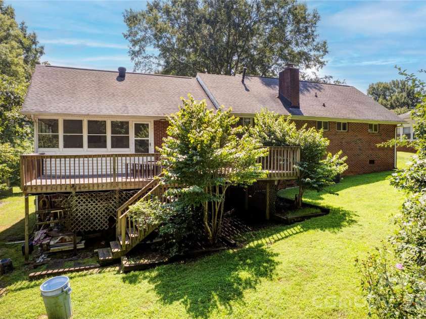 6733 Burkandt Road, Charlotte, NC 28227.  MLS# CAR4413605, YatesRealty ID 43726. Large deck off finished sunroom.