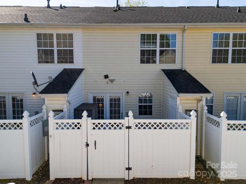 107 Forester Street, Mooresville, NC 28117.  MLS# CAR4241851, YatesRealty ID 4375. Back patio is fully fenced with a storage area.