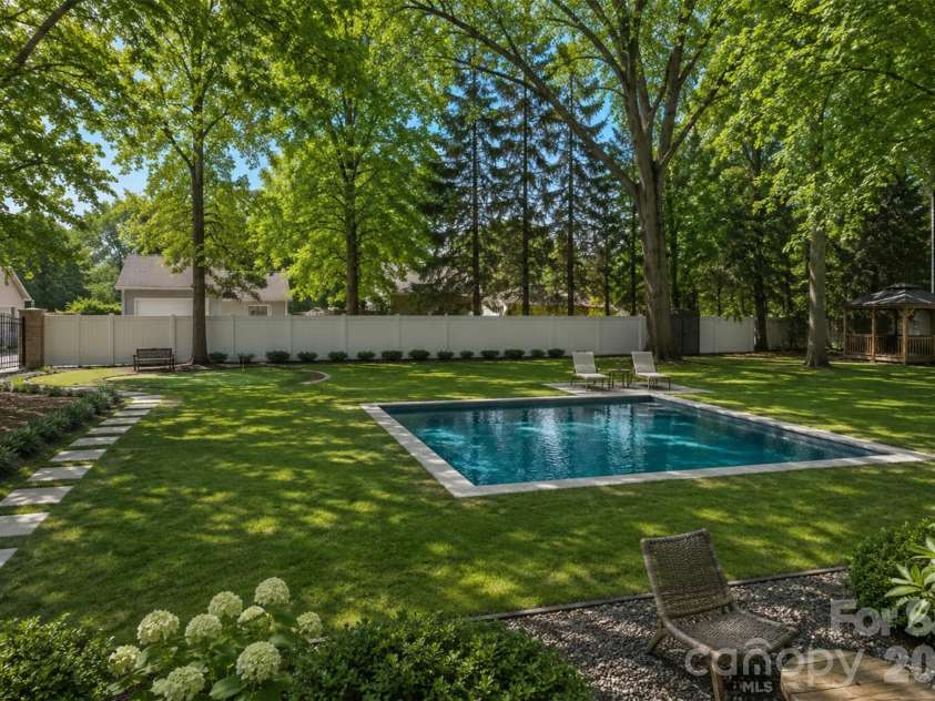 4341 Old Saybrook Court, Charlotte, NC 28211.  MLS# CAR4375795, YatesRealty ID 43751. AI rendering showcases one possibility for adding a pool to the spacious backyard!