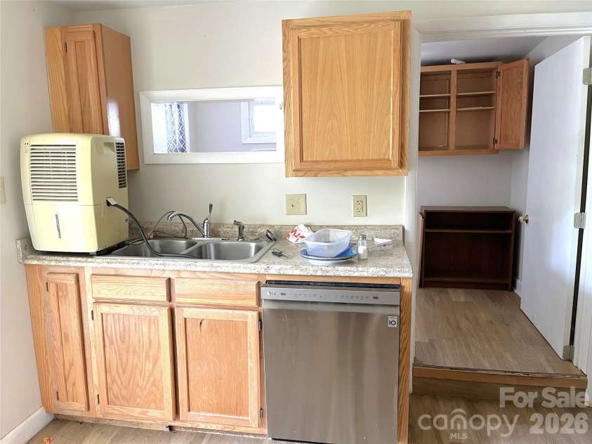 1721 Old Haywood Road, Asheville, NC 28806.  MLS# CAR4409477, YatesRealty ID 43766. Kitchen with laundry behind it.