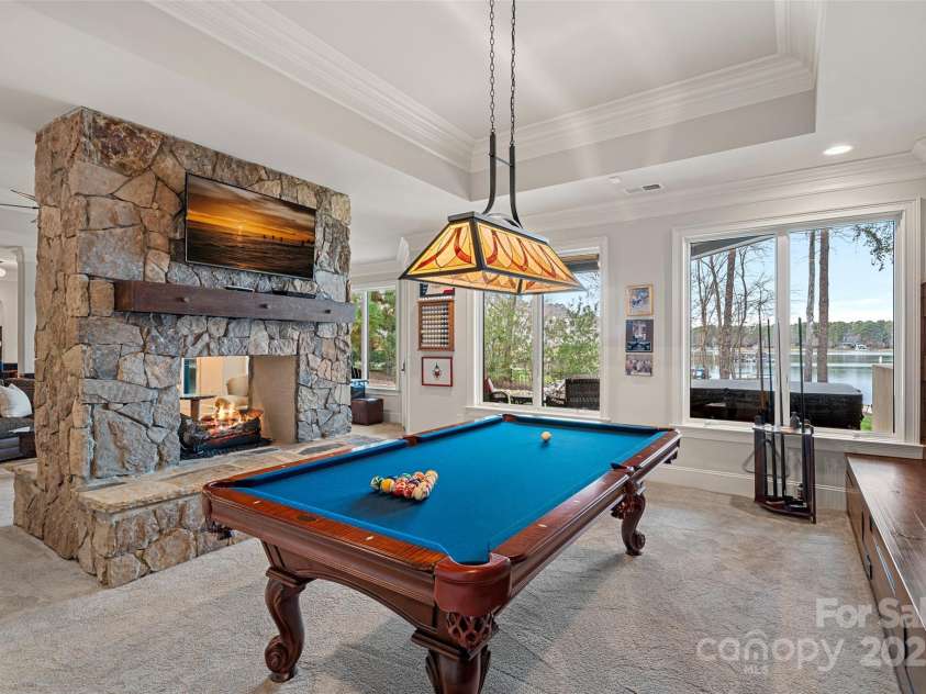130 Brick Kiln Way, Mooresville, NC 28117.  MLS# CAR4232035, YatesRealty ID 4378. Basement Billards area with see-through fireplace