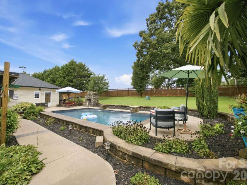 359 Huffstetler Lake Road, Dallas, NC 28034.  MLS# CAR4413475, YatesRealty ID 43785. Stone cap wall surrounds pool