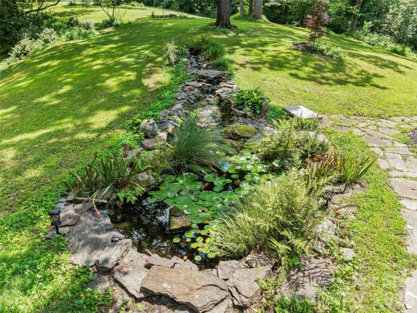 201 Valeria Lane, Pisgah Forest, NC 28768.  MLS# CAR4413829, YatesRealty ID 43787. Illuminated Koi Pond with gentle stream