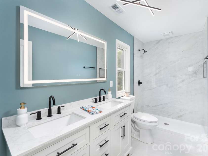 12 Crestfield Avenue, Woodfin, NC 28804.  MLS# CAR4412835, YatesRealty ID 43799. Nice shower and lighted mirrror