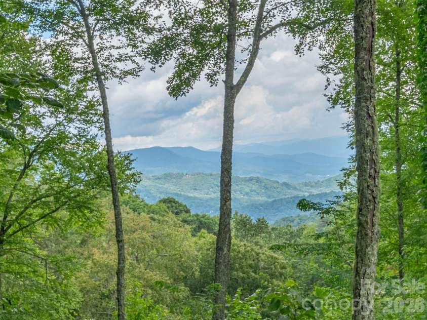 332 Gadohi Trail, Maggie Valley, NC 28751.  MLS# CAR4414080, YatesRealty ID 43811. Layered mtn view from deck and home