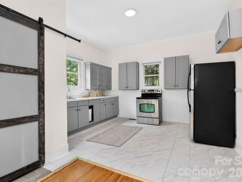 58 Skipwith Street, Concord, NC 28025.  MLS# CAR4413549, YatesRealty ID 43818. Kitchen + Laundry Room Adjacent (virtually staged)