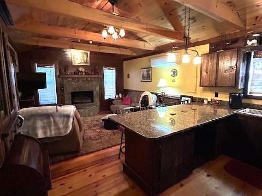116 Minerva Lane, Sapphire, NC 28774.  MLS# CAR4237813, YatesRealty ID 4384. Kitchen and livingroom