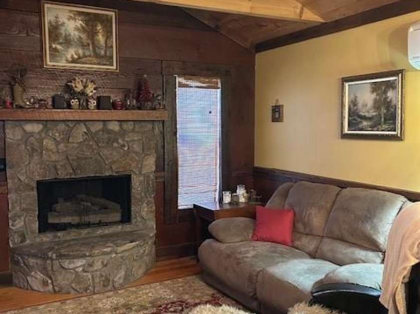 116 Minerva Lane, Sapphire, NC 28774.  MLS# CAR4237813, YatesRealty ID 4384. Stone fireplace with gas logs