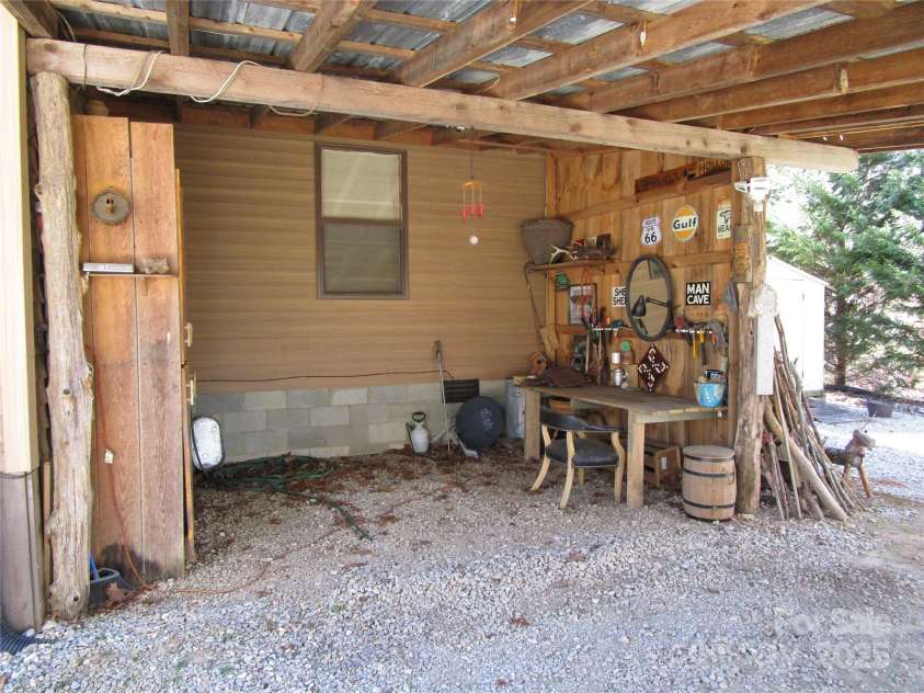 116 Minerva Lane, Sapphire, NC 28774.  MLS# CAR4237813, YatesRealty ID 4384. Workshop area in carport