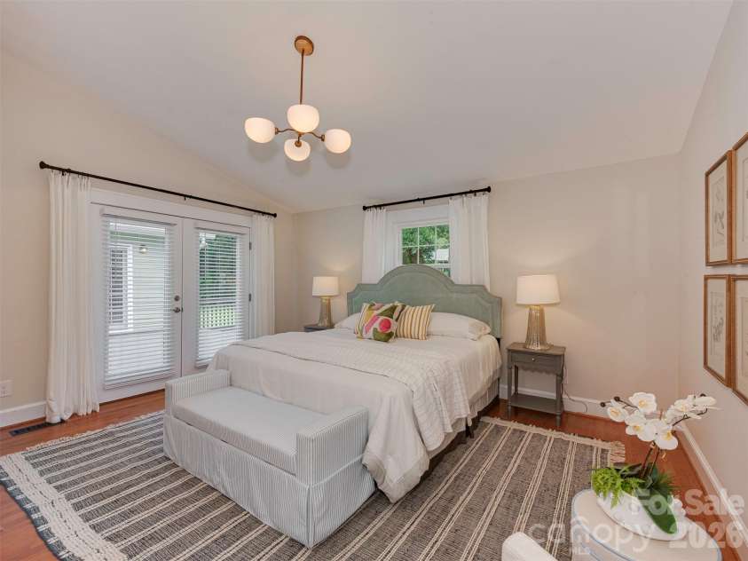 1323 Goodwin Avenue, Charlotte, NC 28205.  MLS# CAR4414214, YatesRealty ID 43861. The primary features a vaulted ceiling and french doors out to the deck.