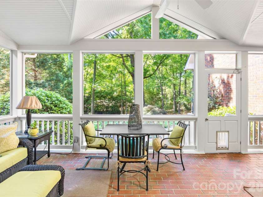4026 Sharon View Road, Charlotte, NC 28226.  MLS# CAR4346910, YatesRealty ID 4390. The screened in covered porch overlooks the mature backyard.