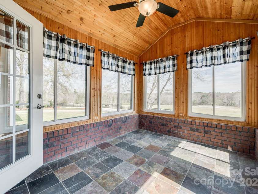 1790 Faires Road, Rock Hill, SC 29730.  MLS# CAR4235758, YatesRealty ID 4393. Beautiful sunroom with endless views of the pond and rolling pasture .