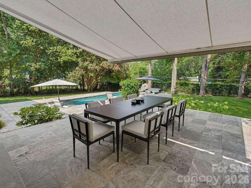 811 Lansdowne Road, Charlotte, NC 28270.  MLS# CAR4412881, YatesRealty ID 43958. Remote-controlled awning creates covered dining.