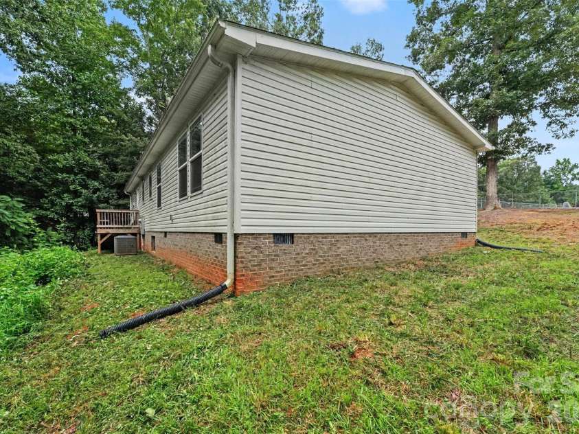 2998 Wilderness Trace, Claremont, NC 28610.  MLS# CAR4413940, YatesRealty ID 43985. Side Exterior