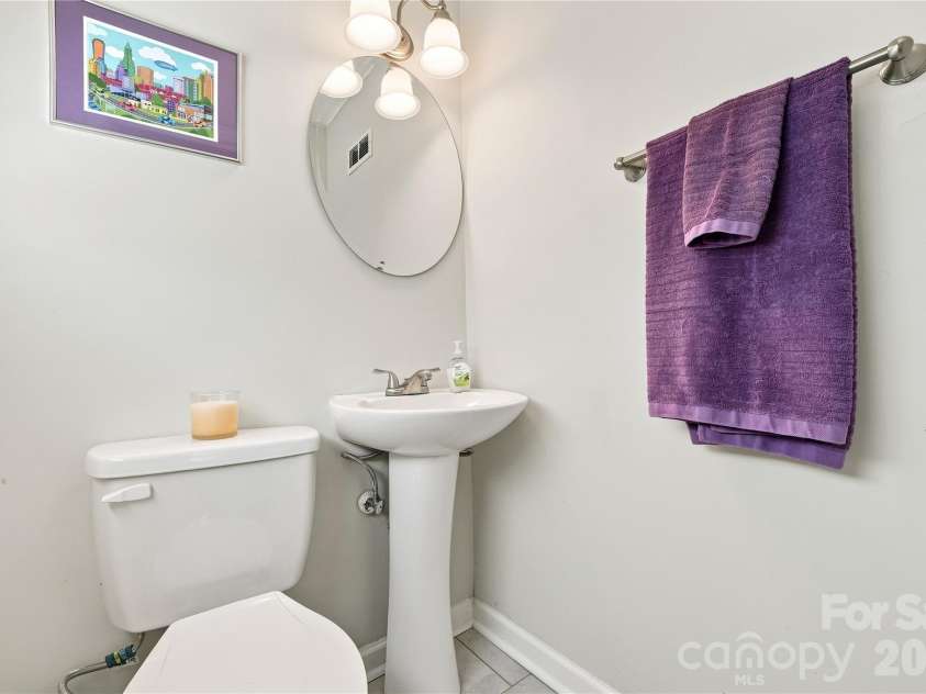 6142 King George Drive, Charlotte, NC 28213.  MLS# CAR4412186, YatesRealty ID 44037. Primary Bedroom Bath featuring updated commode and sink, tile floor, and fresh paint.
