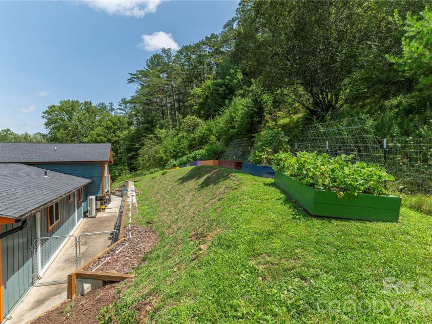 50 Embler Road, Alexander, NC 28701.  MLS# CAR4413083, YatesRealty ID 44048. Bountiful Vegetable beds