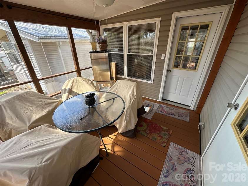 129 Club House Drive, New London, NC 28127.  MLS# CAR4350214, YatesRealty ID 4405. Screened porch at the back of the property 