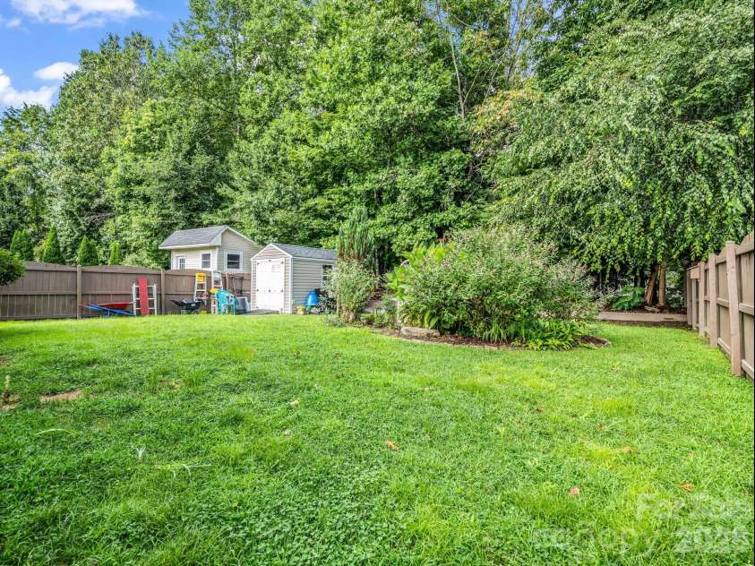 93 Foxtail Court, Hendersonville, NC 28792.  MLS# CAR4414198, YatesRealty ID 44074. Back yard with storage shet