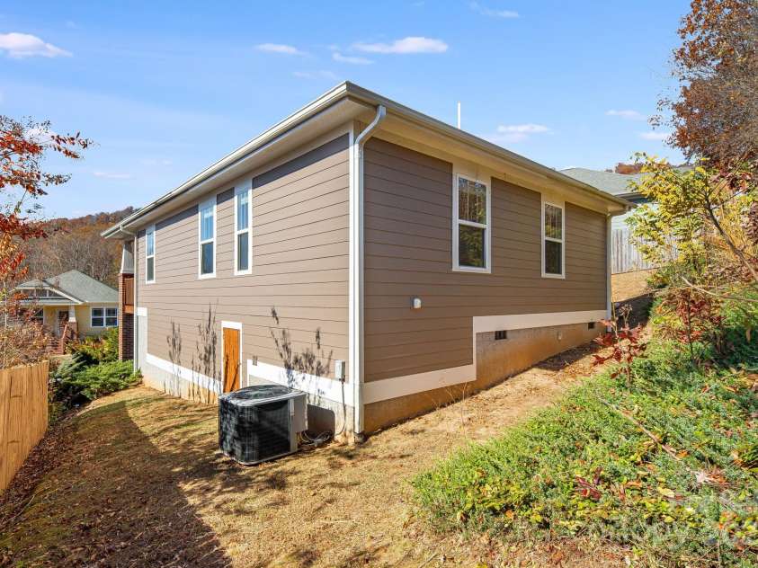 11 Byrdcliffe Lane, Asheville, NC 28805.  MLS# CAR4320731, YatesRealty ID 4411. Back of Home with Storage in Crawlspace