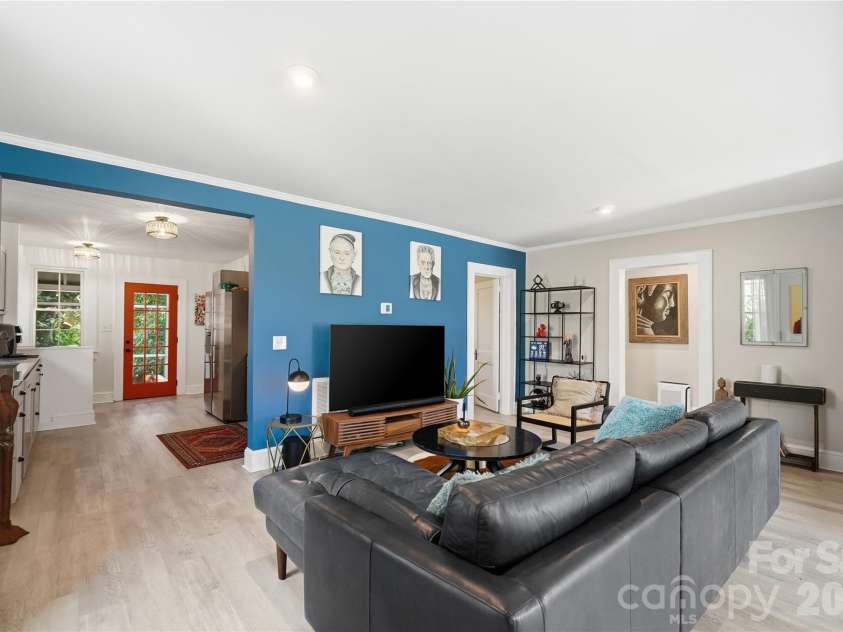 315 Pendleton Street, Rock Hill, SC 29730.  MLS# CAR4412482, YatesRealty ID 44209. A living room with personality. The bold feature wall adds character, while an open layout keeps the kitchen just steps away and the space easy to gather in.