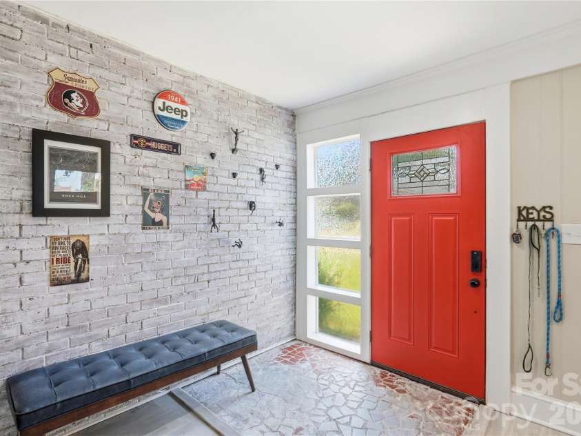 315 Pendleton Street, Rock Hill, SC 29730.  MLS# CAR4412482, YatesRealty ID 44209. The entryway showcases original whitewashed brick, with a sidelight window beside the front door bringing in extra natural light.