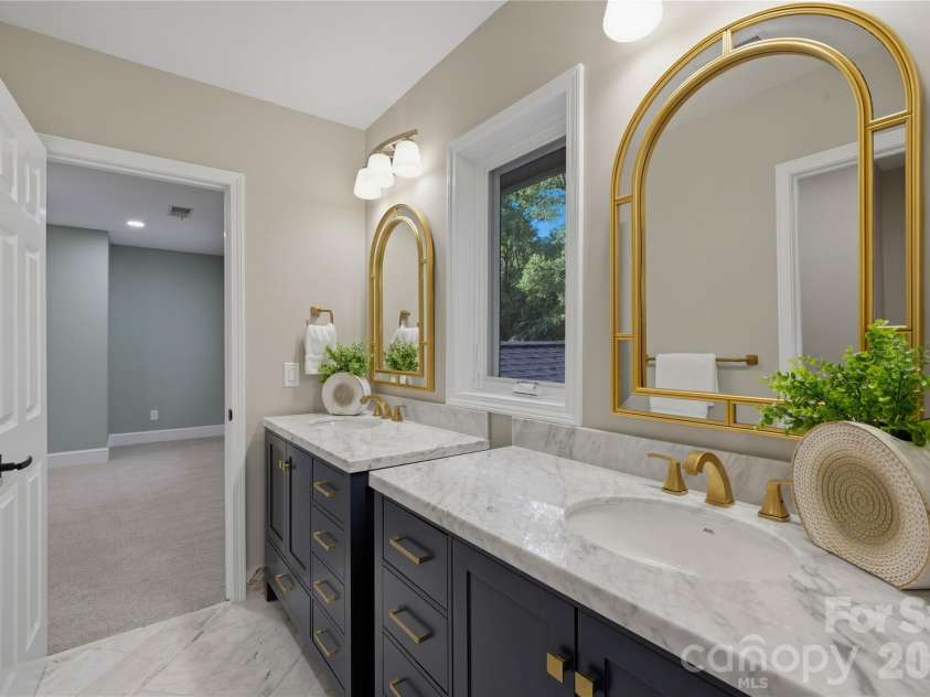 5023 Gorham Drive, Charlotte, NC 28226.  MLS# CAR4402221, YatesRealty ID 44262. Beautifully appointed full bath featuring a spacious vanity, stone countertop, elegant lighting and timeless finishes.