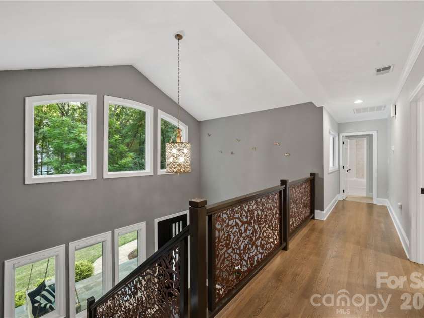 5023 Gorham Drive, Charlotte, NC 28226.  MLS# CAR4402221, YatesRealty ID 44262. Light filled upper level landing overlooking the dramatic foyer, showcasing architectural windows, hardwood floors and the home’s open, airy design.