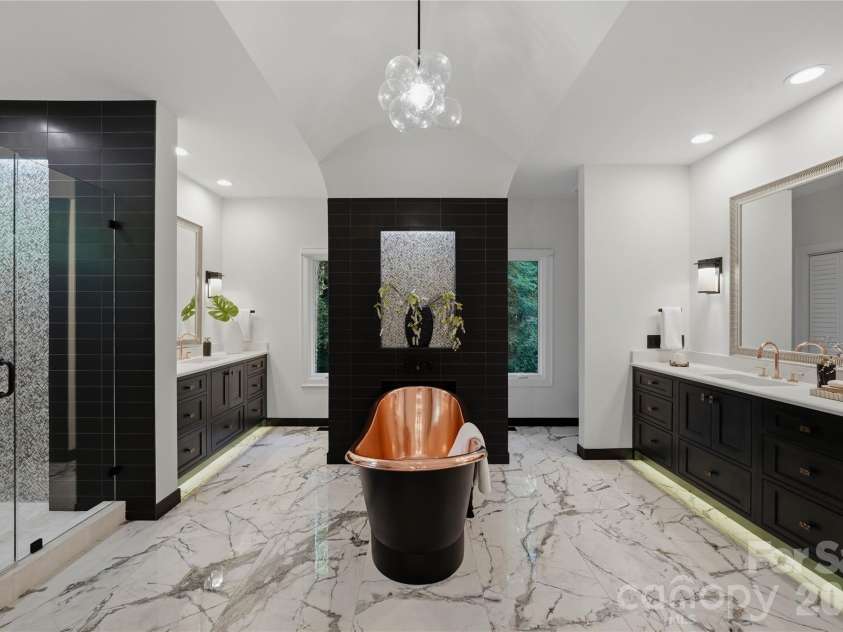 5023 Gorham Drive, Charlotte, NC 28226.  MLS# CAR4402221, YatesRealty ID 44262. Spa inspired primary bath featuring a statement copper soaking tub, expansive dual vanities and sophisticated finishes, creating a luxurious private retreat.
