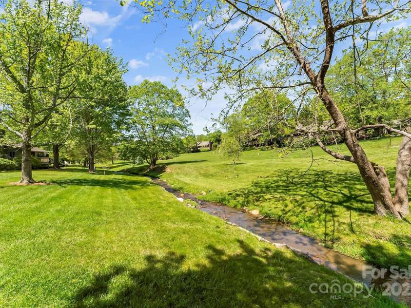 10 Clubside Drive, Asheville, NC 28804.  MLS# CAR4214274, YatesRealty ID 4427. Creek Behind Home In The Spring