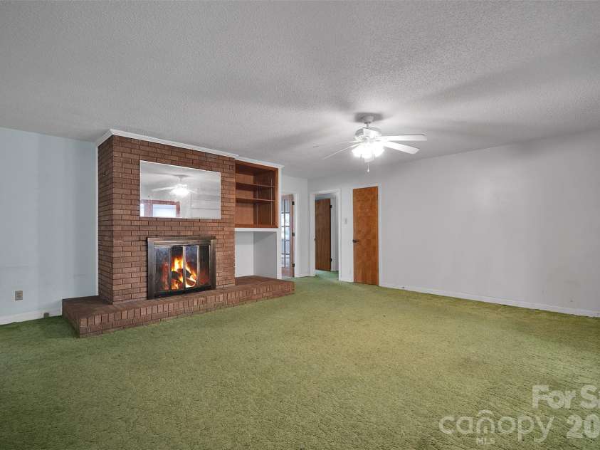 1202 Midwood Drive, Monroe, NC 28112.  MLS# CAR4356506, YatesRealty ID 4429. Virtual Stage Fire in Fireplace