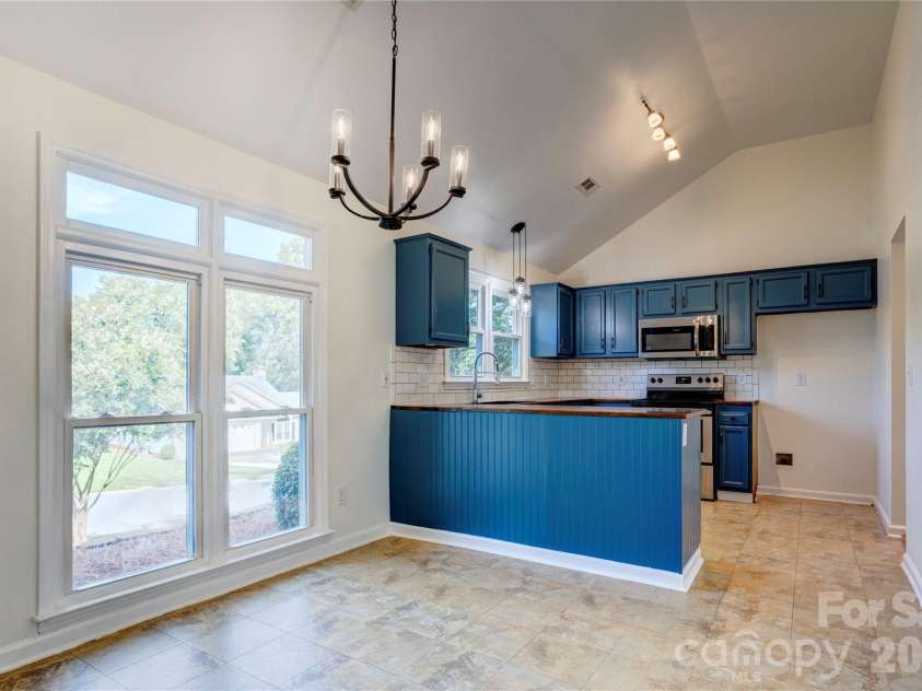 156 Edgewater Drive, Concord, NC 28027.  MLS# CAR4413561, YatesRealty ID 44298. Beautiful kitchen with updated lighting
