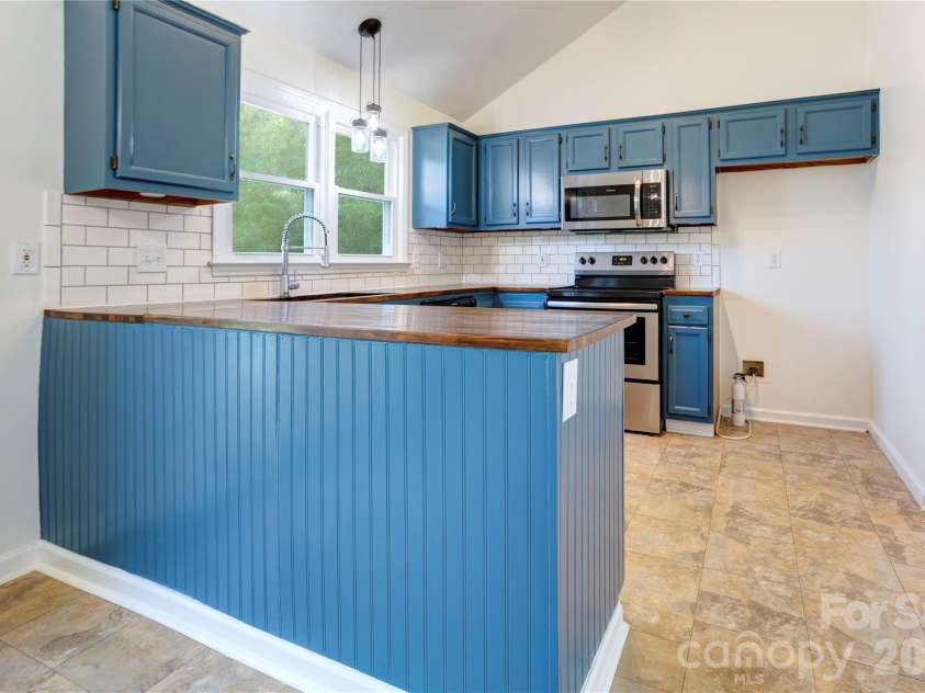 156 Edgewater Drive, Concord, NC 28027.  MLS# CAR4413561, YatesRealty ID 44298. Butcher block counter tops and tile backsplash