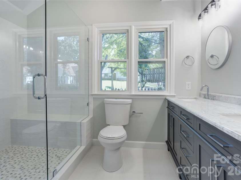 156 Edgewater Drive, Concord, NC 28027.  MLS# CAR4413561, YatesRealty ID 44298. Primary bath with newly updated shower, flooring, lighting & double vanity