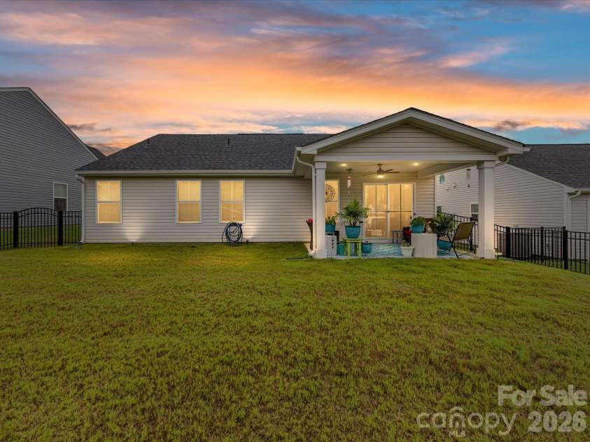 557 Nesbe Street, Lancaster, SC 29720.  MLS# CAR4411330, YatesRealty ID 44303. Twilight View of Rear Elevation and Covered Patio