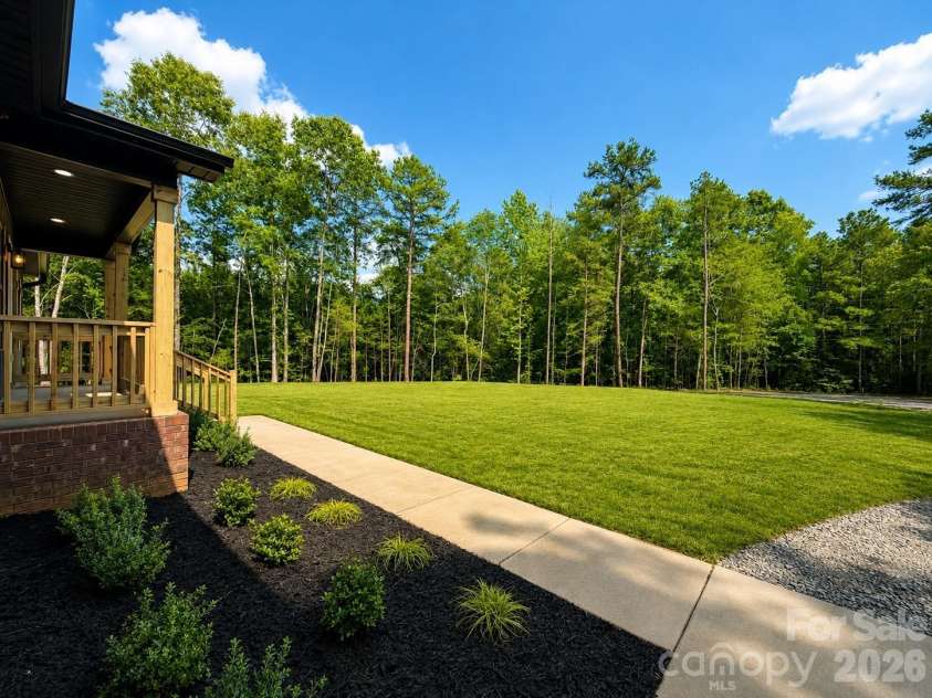 2697 Kendelwood Drive, Lancaster, SC 29720.  MLS# CAR4409067, YatesRealty ID 44346. Front yard with trees for privacy*virtually added grass