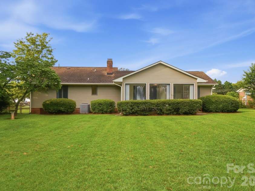197 Park Road, Mount Holly, NC 28120.  MLS# CAR4414607, YatesRealty ID 44348. Sunroom Overlooks This Expansive Backyard