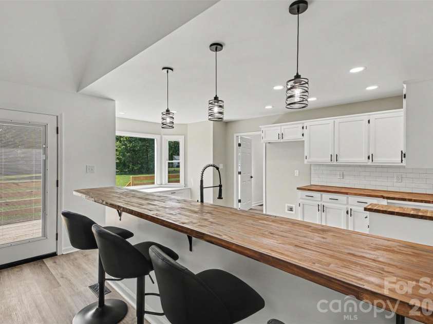 8379 Harvell Road, Stanfield, NC 28163.  MLS# CAR4410609, YatesRealty ID 44417. Bar and beautifully updated kitchen