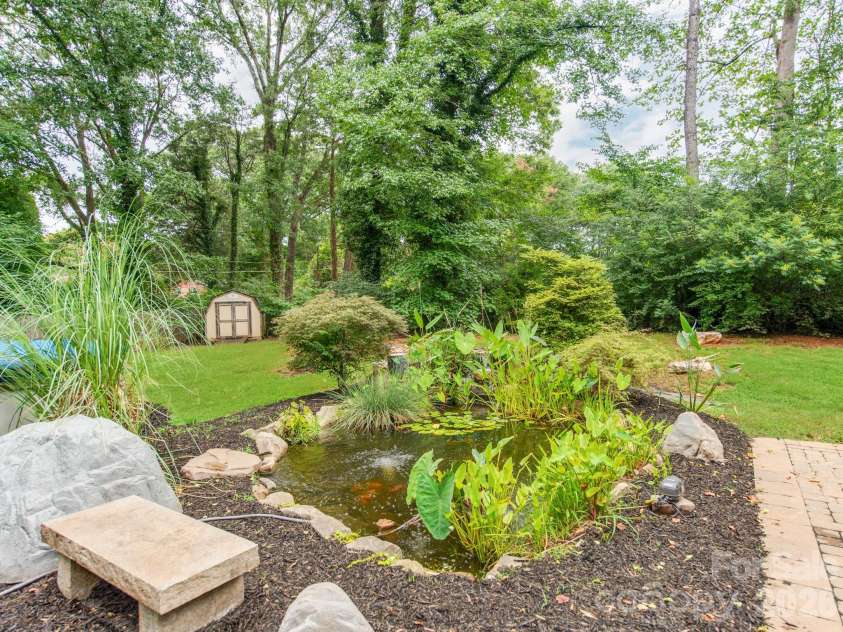 3021 Cresthill Drive, Charlotte, NC 28212.  MLS# CAR4413066, YatesRealty ID 44424. Self-sufficient Waterfall Koi pond & Second Shed
