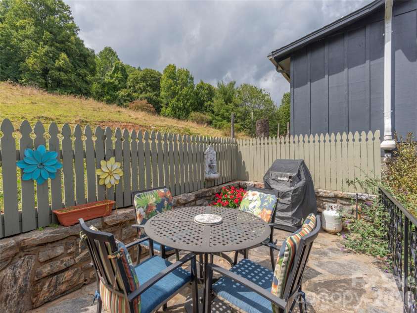 21 Flint Lane, Maggie Valley, NC 28751.  MLS# CAR4354413, YatesRealty ID 4443. Patio adjacent to pasture 